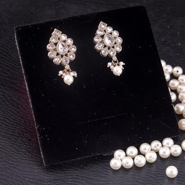 Oval shape white uncut kundan stone antique gold plated jhumki earrings that sit below the temple arm of glasses