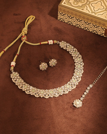 Light green uncut kundan flower design choker necklace set for a tilak ceremony